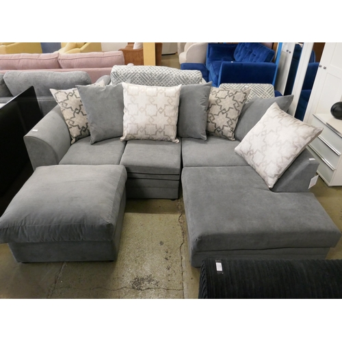 1586 - A grey upholstered corner sofa and footstool