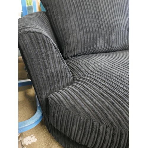 1600 - A black jumbo cord swivel armchair and footstool