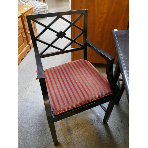 1611 - An ebonised extending dining table and eight chairs