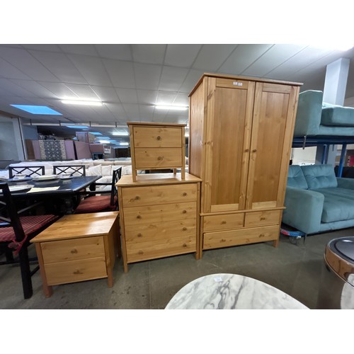 1610 - Pine bedroom suite comprising of two bedside chests a double wardrobe and a four drawer chest - boxe... 