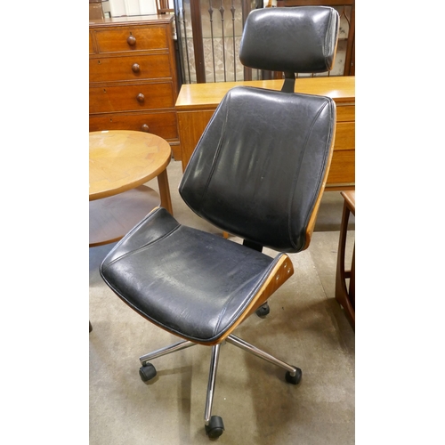 1 - An Eames style simulated rosewood, chrome and black leather revolving desk chair