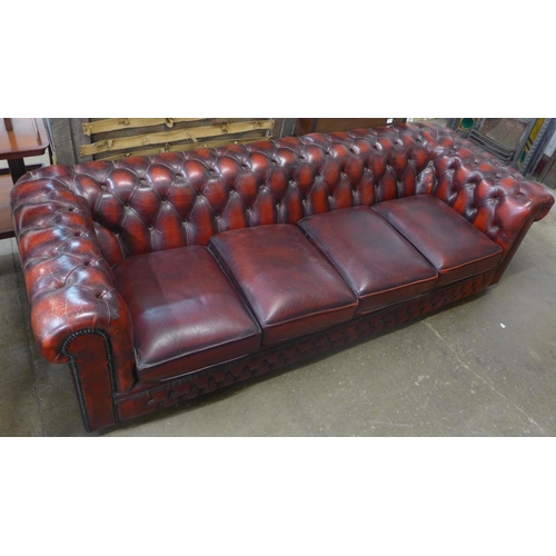 108 - An oxblood red leather Chesterfield settee