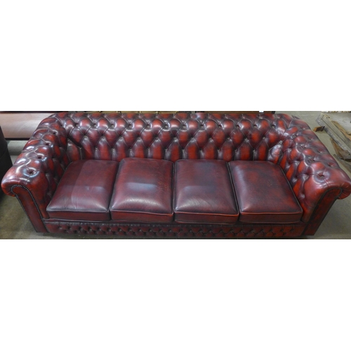 108 - An oxblood red leather Chesterfield settee