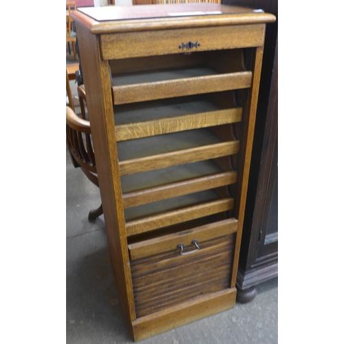 110 - An early 20th Century oak tambour front filing cabinet (lacking key)