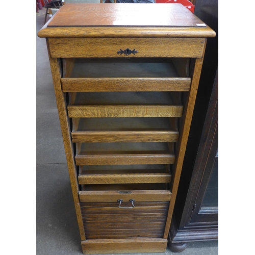 110 - An early 20th Century oak tambour front filing cabinet (lacking key)