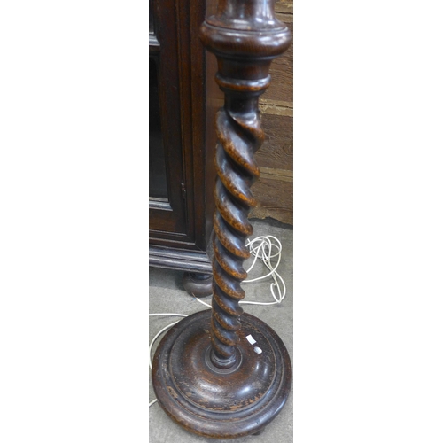 116 - An oak barleytwist standard lamp