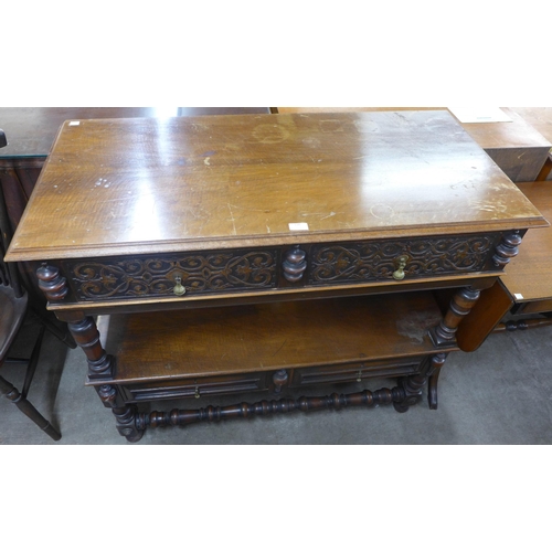 118 - A late Victorian Elizabethan Revival carved walnut two drawer buffet