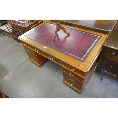 129 - A late Victorian mahogany and red leather topped desk