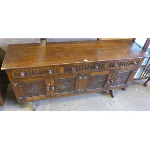 132 - A carved oak sideboard