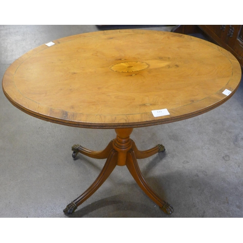 133 - A Regency style inlaid yew wood tripod wine table