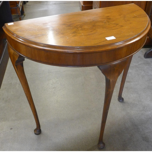 142 - A walnut demi-lune hall table