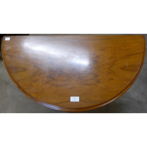 142 - A walnut demi-lune hall table