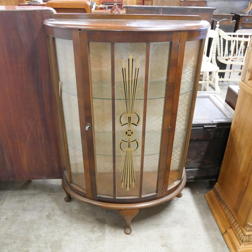 210 - A walnut single door display cabinet