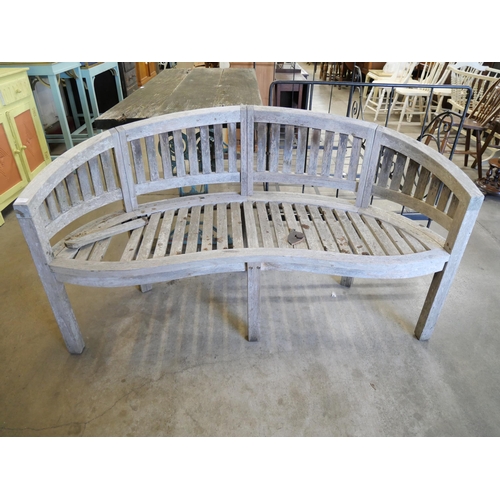 214 - A teak demi-lune garden bench