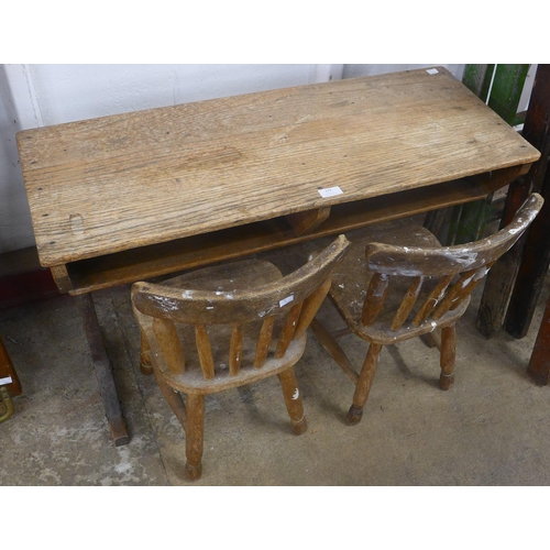 229 - An early 20th century elm child's desk and two chairs