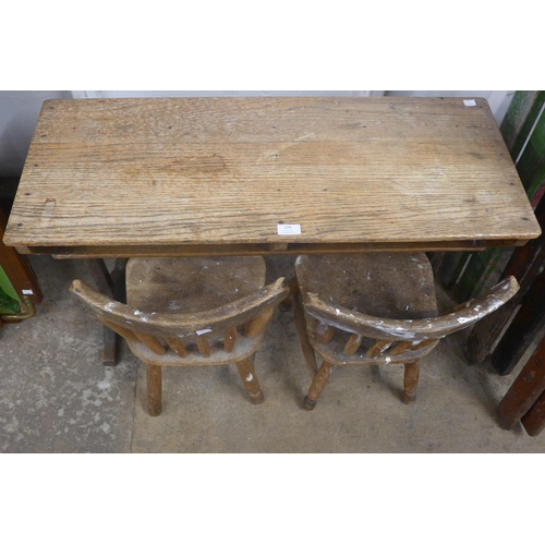 229 - An early 20th century elm child's desk and two chairs