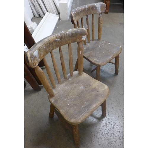 229 - An early 20th century elm child's desk and two chairs