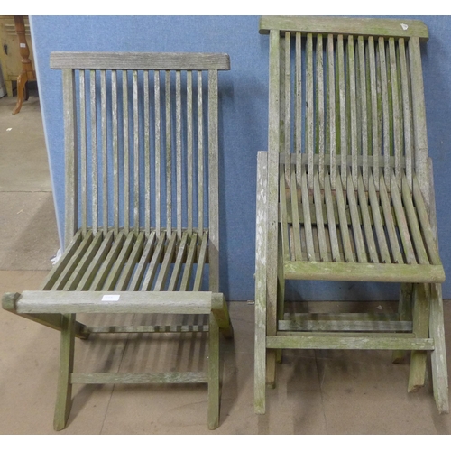 233 - Four teak folding garden chairs