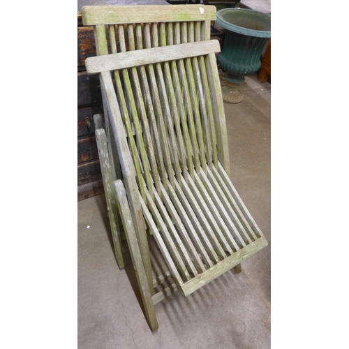 233 - Four teak folding garden chairs