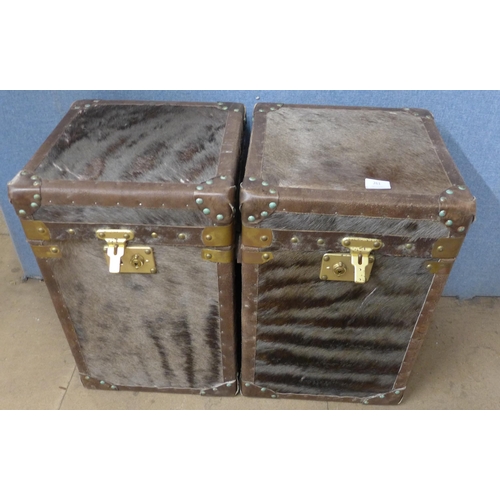 261 - A pair of hide covered and brass mounted trunks