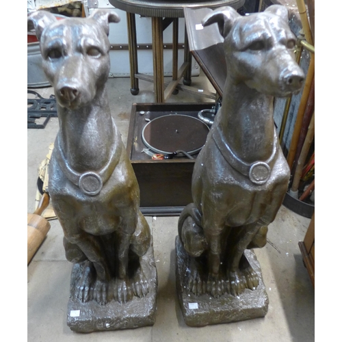 263 - A pair of faux bronze garden figures of seated hounds