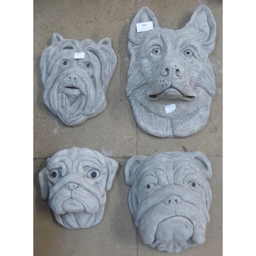 266 - Four concrete dogs heads