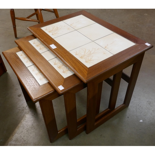31 - A Danish teak and tiled top nest of tables