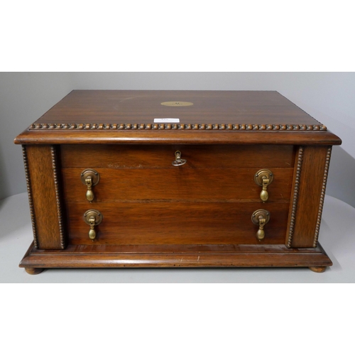 325 - An early 20th Century oak cased canteen of cutlery with faux ivory handles, including a carvery set,... 