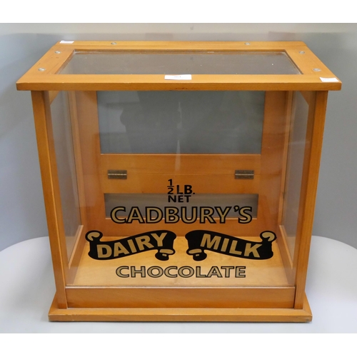 361 - An oak counter top shop cabinet, bearing Cadbury's Dairy Milk inscription