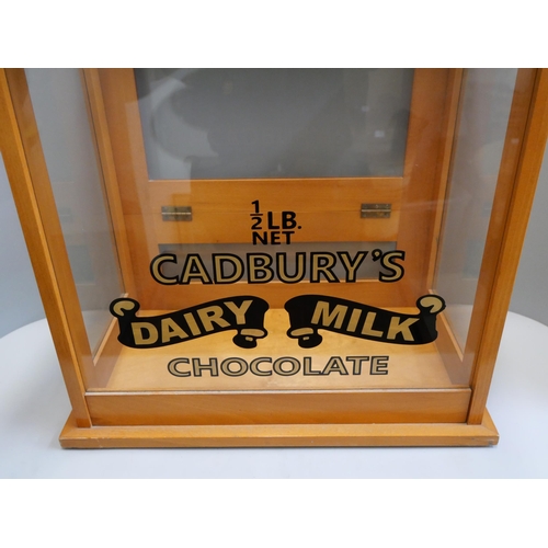 361 - An oak counter top shop cabinet, bearing Cadbury's Dairy Milk inscription