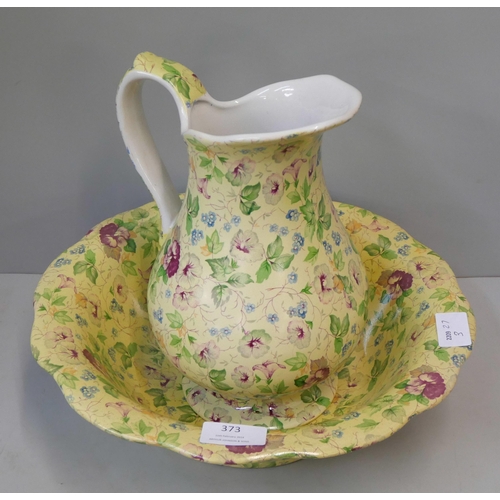 373 - A chintz porcelain wash jug and bowl