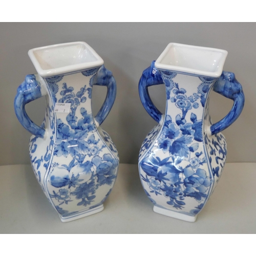 375 - A pair of oriental blue and white porcelain vases