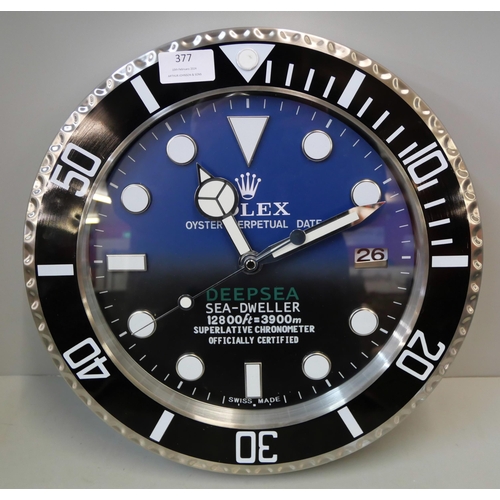 377 - A Rolex style dealers display wall clock