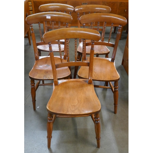 64 - A set of five Victorian elm and beech kitchen chairs