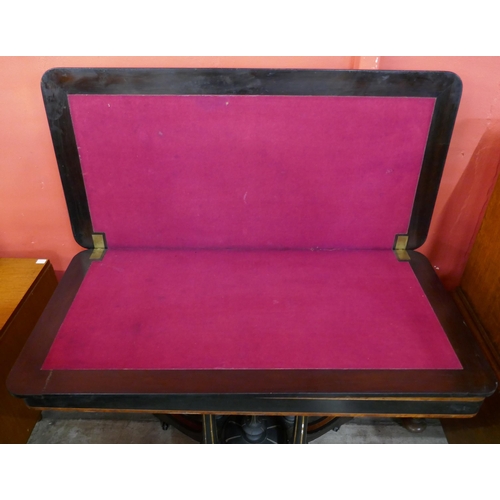 66 - A Victorian ebonised and amboyna rectangular fold over card table, manner of Lambs, Manchester