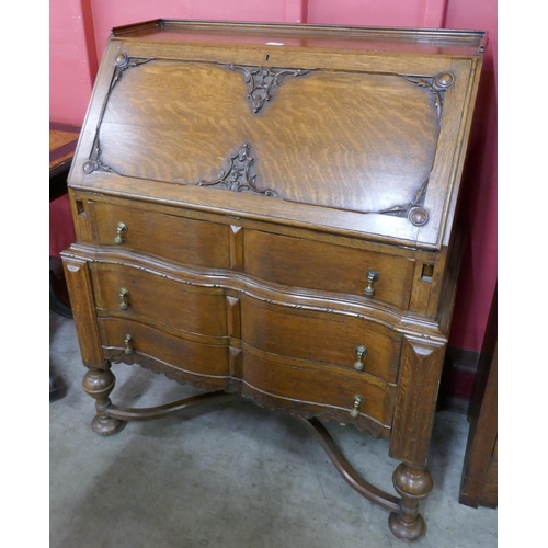 69 - An early 20th Century oak cantilever action bureau