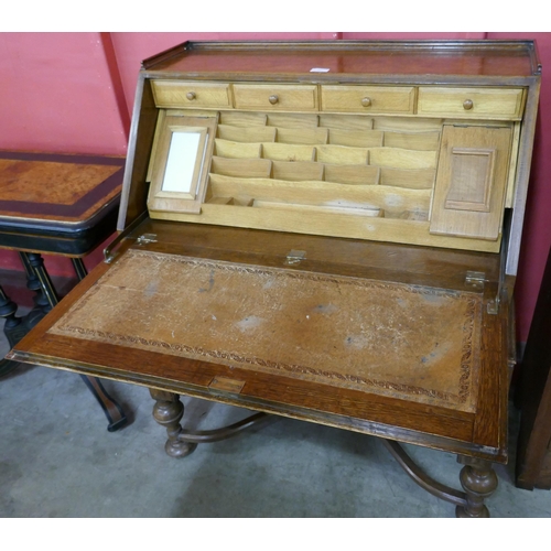 69 - An early 20th Century oak cantilever action bureau