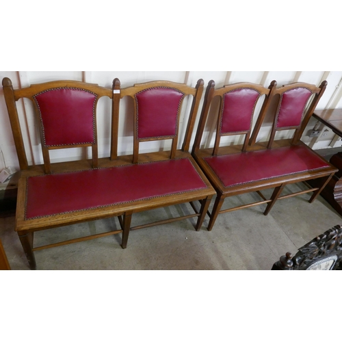 74 - A pair of Arts and Crafts oak and red leather settles