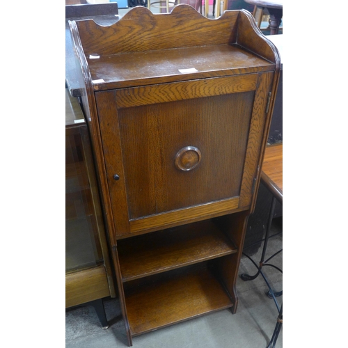 83 - An oak single door open bookcase