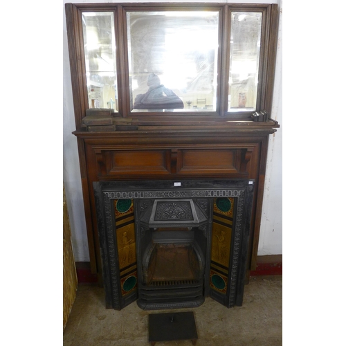 94 - An Edward VII walnut chimney-piece with tiled back cast iron fire surround