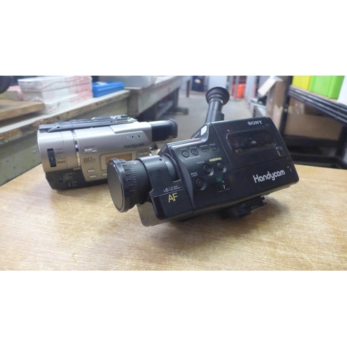 2081 - A large quantity of various cameras including: a Sony handicam (CCDF340E), a Sharp camcorder (VL-E34... 