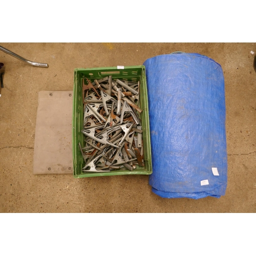 2334 - A large blue tarpaulin and basket of approx. 50 stall clips