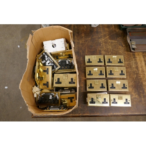 2342 - A large quantity of brass plated double socket wall switches