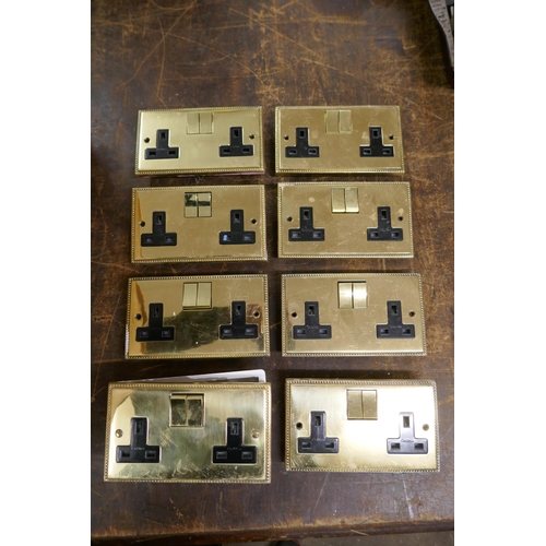 2342 - A large quantity of brass plated double socket wall switches