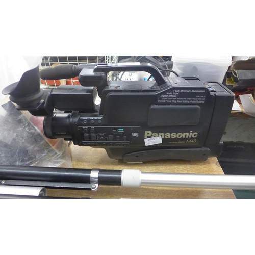 2080 - A Panasonic M40 video camera with tapes, tripod stand and roller