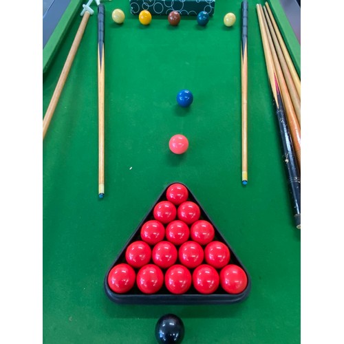 2206 - A darkwood slate bed pool table with cues, ball, score board