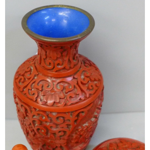 633 - A Japanese carved cinnabar vase, lidded circular pot and a porcelain scent bottle