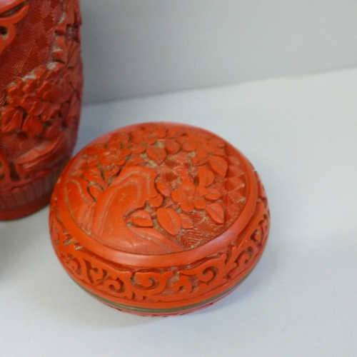 633 - A Japanese carved cinnabar vase, lidded circular pot and a porcelain scent bottle