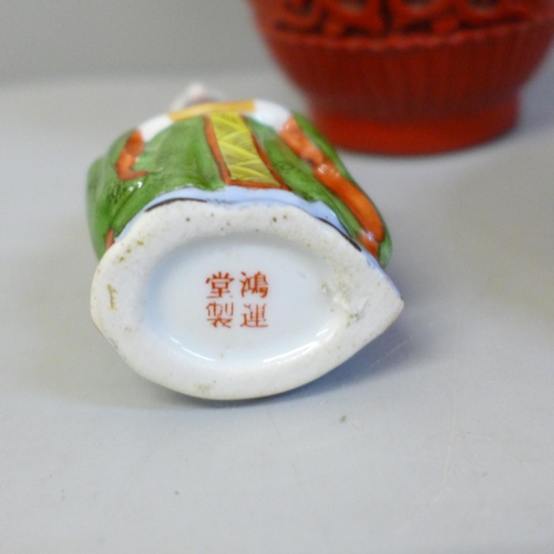 633 - A Japanese carved cinnabar vase, lidded circular pot and a porcelain scent bottle