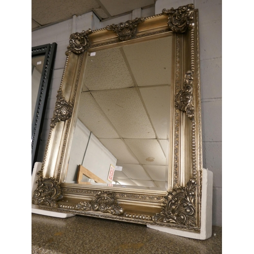 1483 - An ornate silver framed mirror